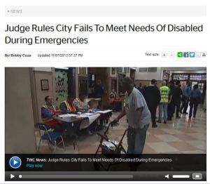 Story from NY1 web page headlined "Judge Rules City Fails To Meet Needs Of Disabled During Emergencies" and a video image of an African American woman using a walker at a NY City hurricane shelter
